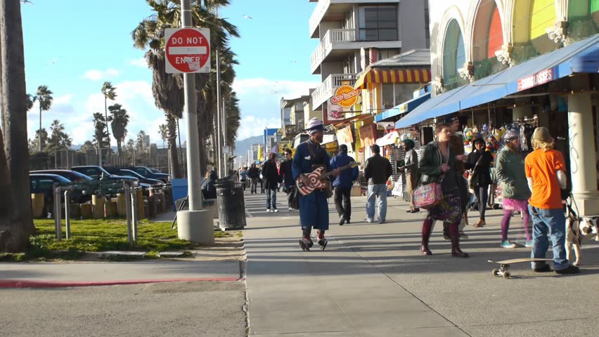 VENICE BEACH, CALIFORNIA - CIRCA 2011:  Tourists and locals walk on the boardwalk at Venice Beach, CA .