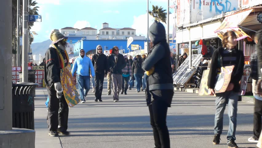 VENICE BEACH, CALIFORNIA - CIRCA 2011:  Tourists and locals walk on the boardwalk at Venice Beach, CA .