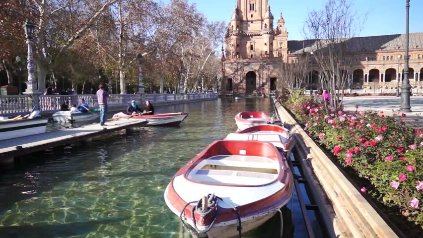 SEVILLE, SPAIN - JANUARY 6: Tourists enjoy a trip on boat on Plaza de Espana Seville on Jan 6, 2013 It was built in 1928 for the Ibero-American Exposition of 1929 designed by architect Anibal Gonzalez