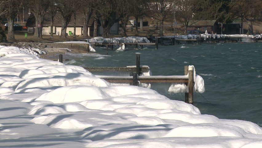 Extreme Lake Shore Ice And Flying Gulls. Thick ice coats the shore of Lake Geneva after record breaking cold weather hits Europe in February 2012. Shot in Full HD 1920x1080 30 on Sony EX1 