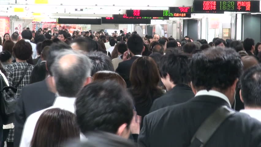 TOKYO, JAPAN - 15 OCTOBER 2012: Train and subway passengers make their way through the massive Shinjuku station in Tokyo, Japan
