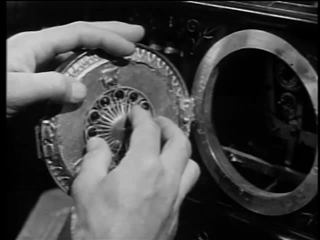 Man discovering hidden diamonds behind clock dial