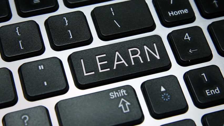 Learn & Lead. Tracking shot of computer keyboard keys LEARN and LEAD.