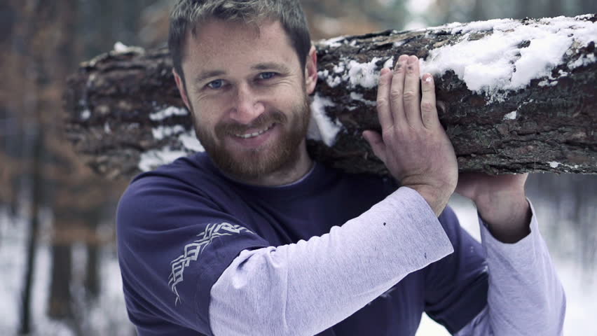 Portrait of happy lumberjack with log, super slow motion, shot at 240fps
