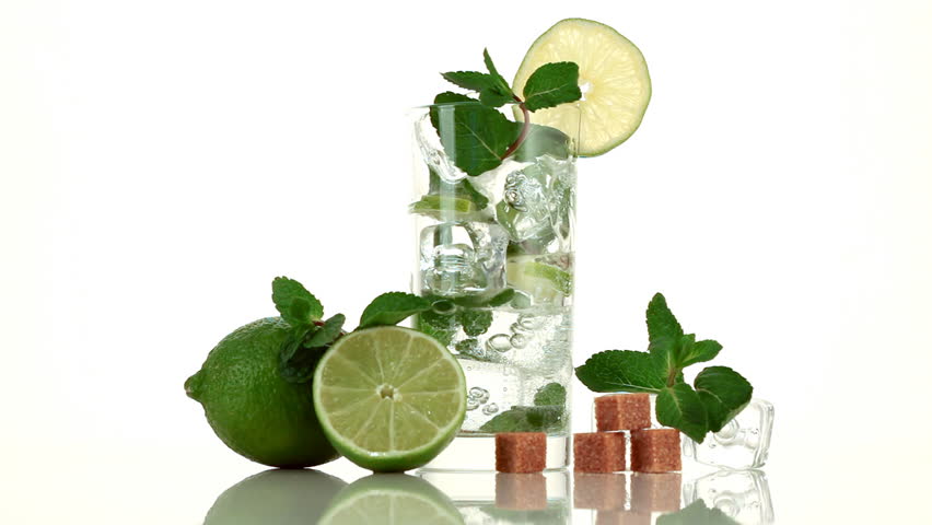 Pouring soda in mojito. Glass, lime, sugar, ice and mint
