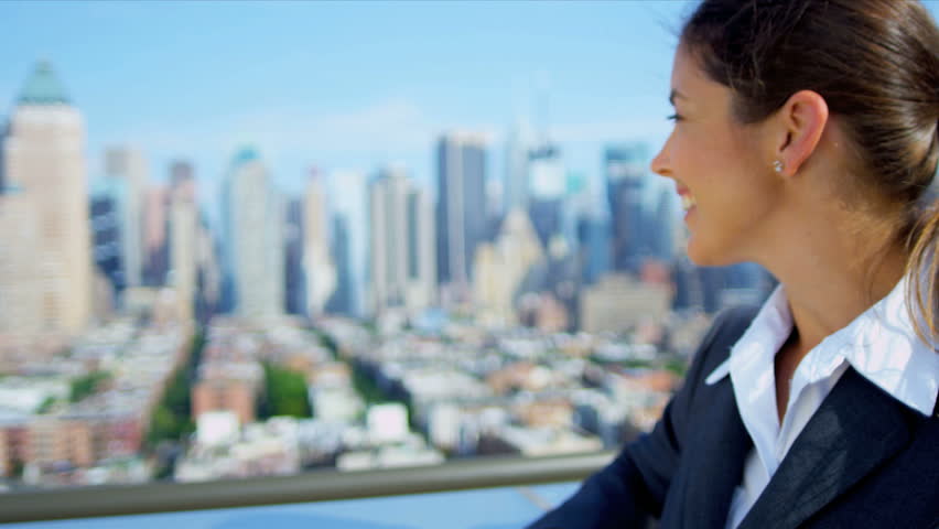Portrait of successful Caucasian female executive manager on rooftop overlooking city