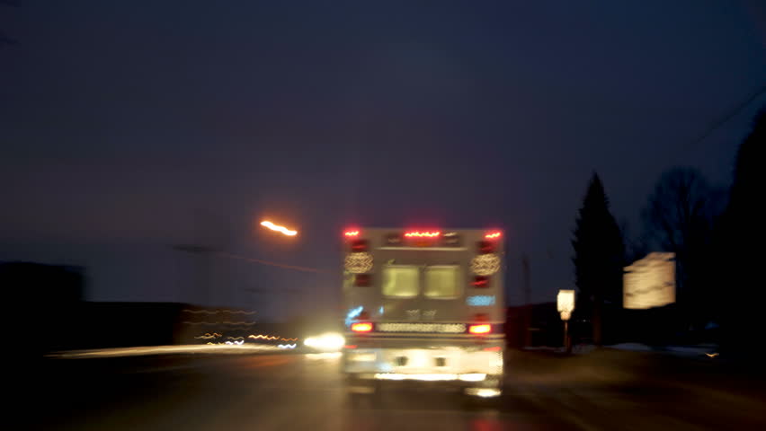 time-lapsed drive behind an on duty ambulance as it makes it's way through town to the hospital. Lights are on, but not flashing.
