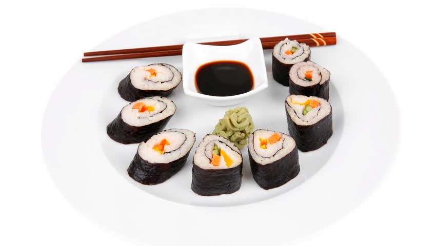 Maki Sushi : Maki Rolls and California rolls made of fresh raw Salmon(sake) Tuna(maguro) and Eel(unagi) . on white dish with sticks hidef slow motion intro