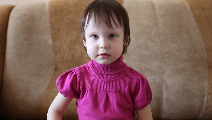 A little girl eating an Apple.