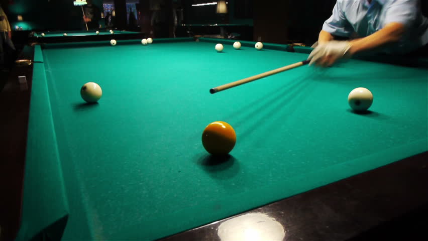 Playing pool, hitting the ball closeup view