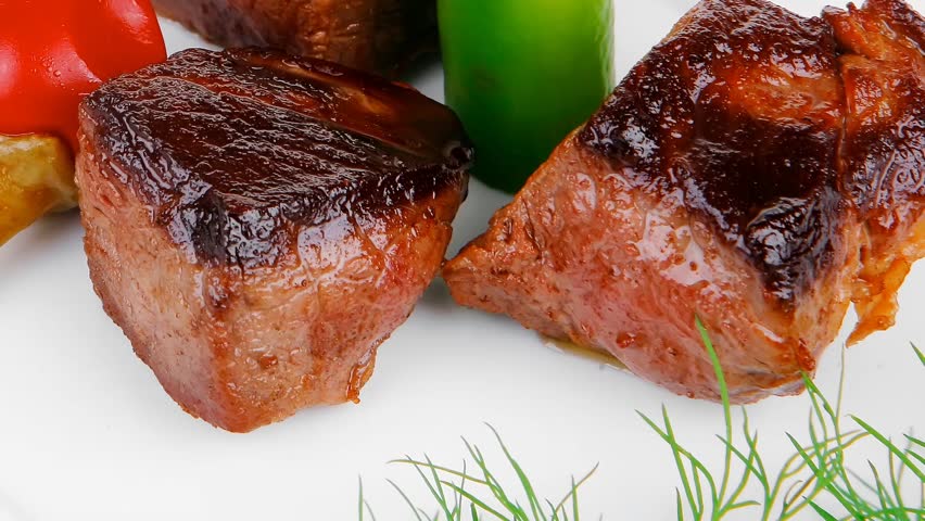 european food: roast beef meat goulash over white plate hidef slow motion intro with tomatoes and dill