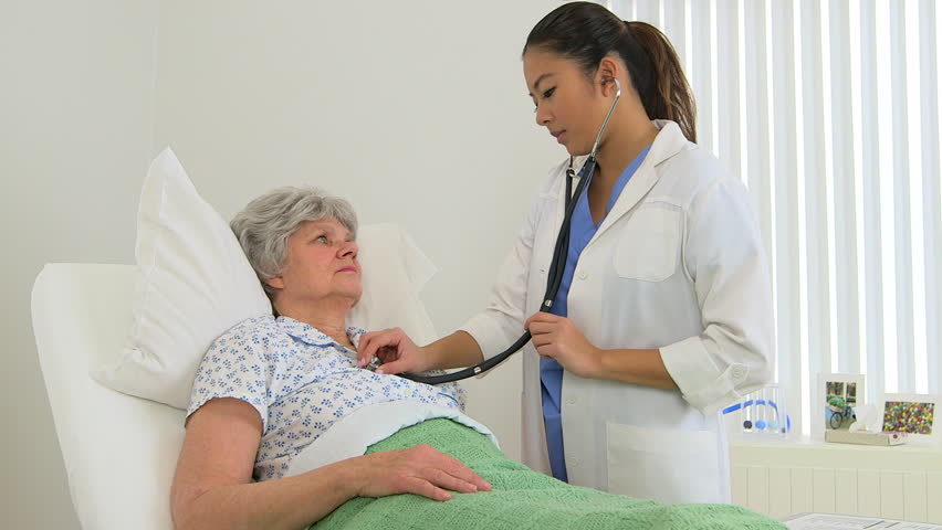 Female multiracial doctor performing a checkup on her patient