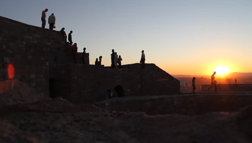 People on the wall of Ankara fortress at sunset, Turkey
