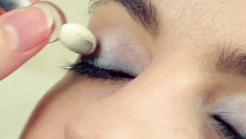 Make-up artist applying make-up on model