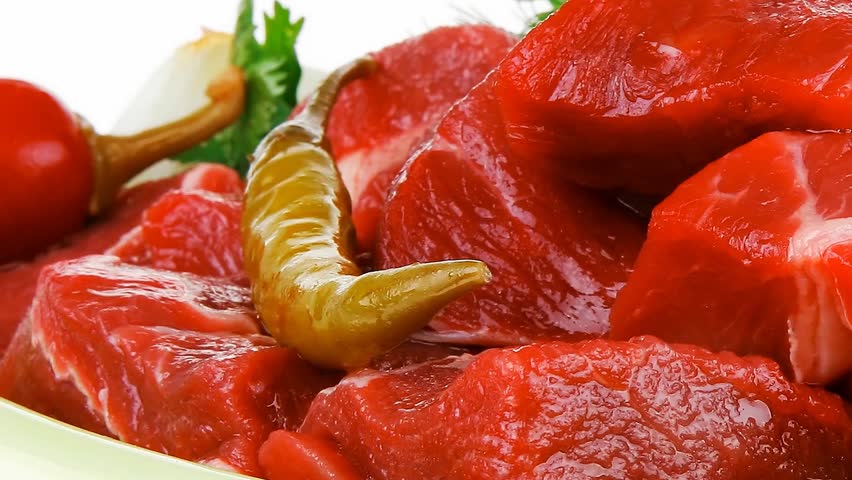 raw fresh beef meat slices in a ceramic dish with onion and red peppers hidef slow motion intro backkground