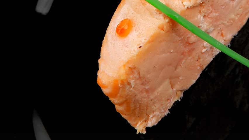 savory fish : norwegian salmon fillet roasted with green onion pen red caviar in spoon on black dish hidef slow motion intro