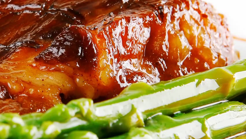 served roasted beef meat with asparagus on white dish