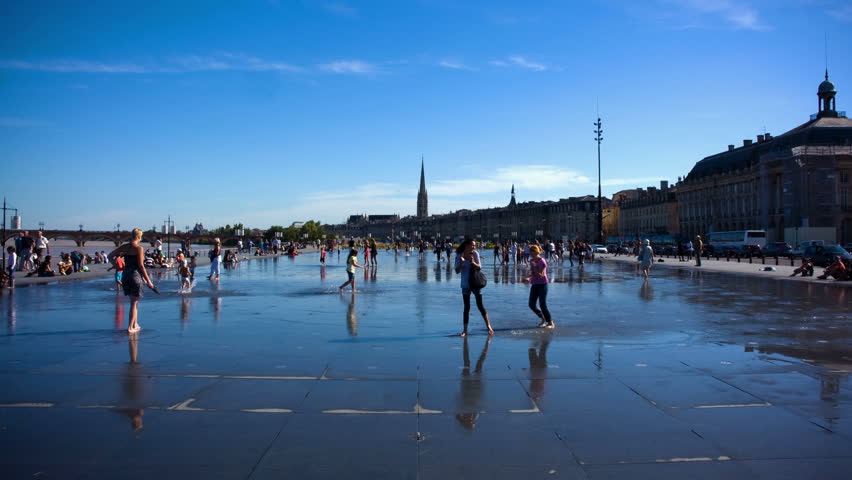 BORDEAUX, FRANCE â SEPTEMBER 15: Time lapse of people and children playing at the water mirror on september 15th, 2010 in Bordeaux, France.