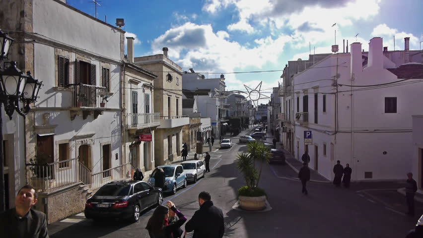 ALBEROBELLO, ITALY - December, 18: Street leading to Saint Cosma and Damiano Basilica on December, 18, 2012, Alberobello, Italy. Alberobello is UNESCO World Heritage Site highly visited all year round