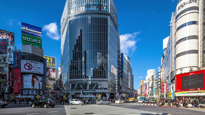 TOKYO, JAPAN - DECEMBER 29: People and cars cross the famous intersection in Shibuya, Tokyo in time lapse on December 29, 2012. It is one of the most heavily used diagonal crossings in the world.