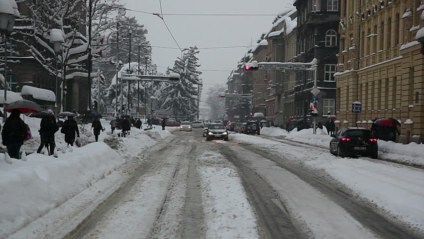 ZAGREB, CROATIA - JANUARY 14: Crossroads in the town center while heavy snowing in working hours and vehicles passing by on January 14, 2012 in Zagreb, Croatia