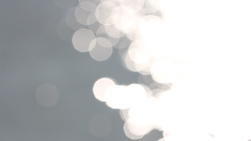 beautiful bokeh reflection of sunlight on water