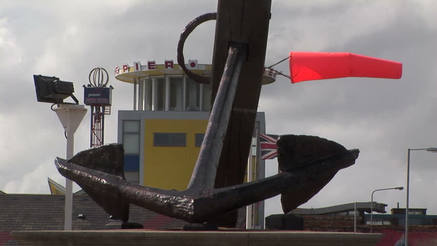 Cast iron Anchor with windsock and Union Jack flag in background