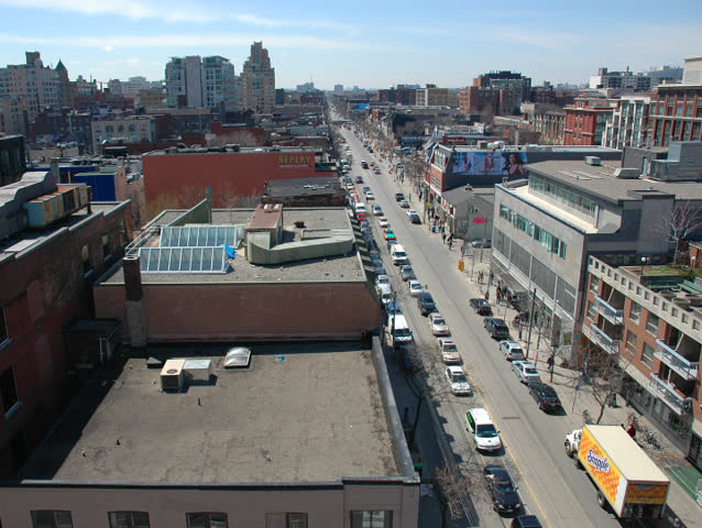 Time lapse of the city in the afternoon from roof-top. Cars, people and blue sky.