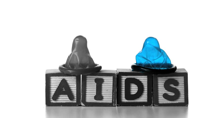 Condoms falling on blocks spelling AIDS in slow motion