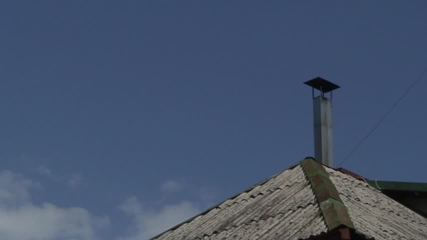 Time-lapse of clouds above the roof at midday 