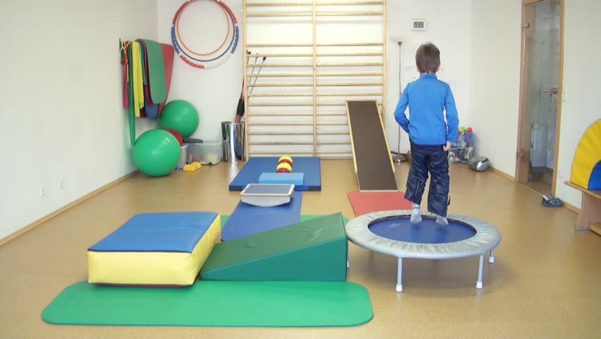 Child does therapeutic exercises in the gym