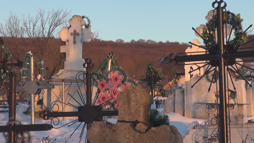 Panoramic view of cross in cemetery during winter time