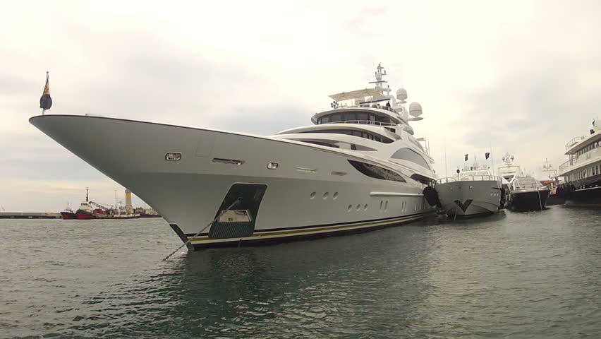 cruising past bow of large Super Yacht in Cannes, France