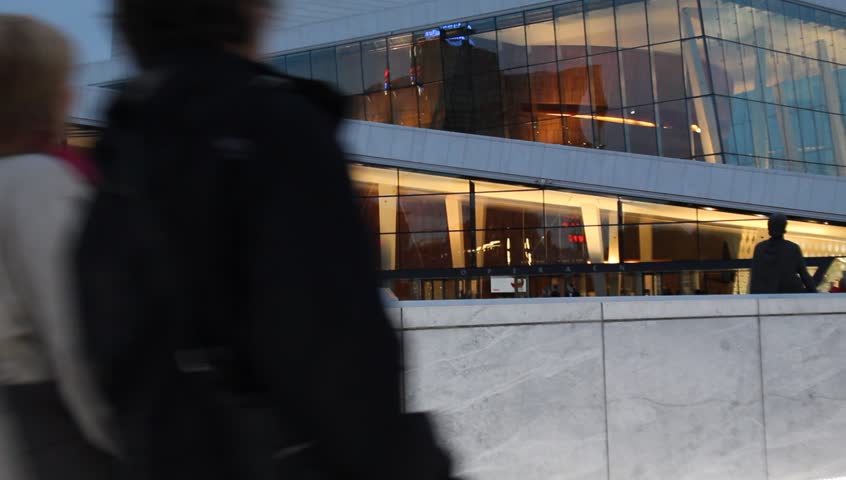 Oslo, Norway - Circa 2011: people walk past a Modern Opera House at dusk