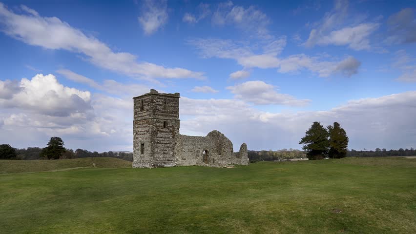 Time Lapse of clouds flowing over the ancient ruins of a Mediaeval church that sits in the center of a Neolithic henge.