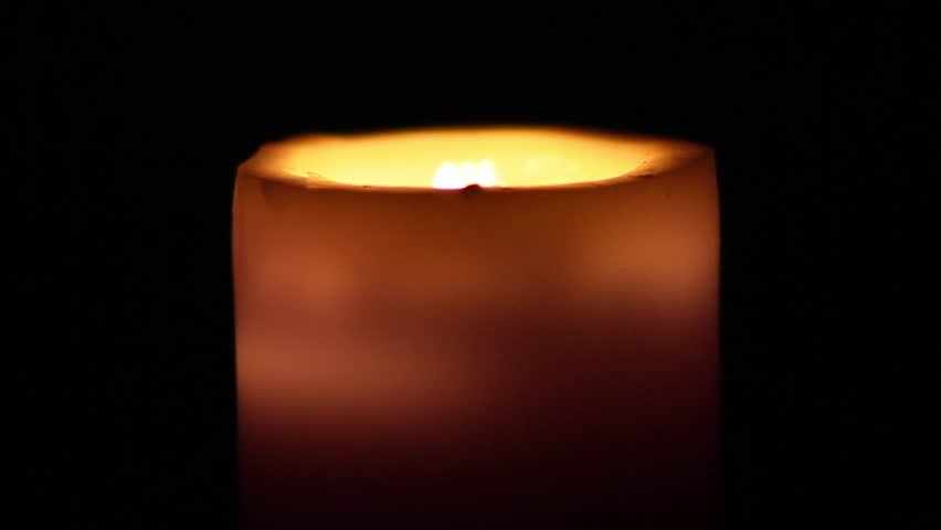 Burning wax candle in the dark. Candle Wax
