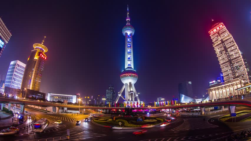 SHANGHAI - CIRCA 2013: Time Lapse of Night view of the East Pearl Tower on the Pedestrian Ring in Pudong, Shanghai, China. Clear night with crowds traffic and automobile traffic