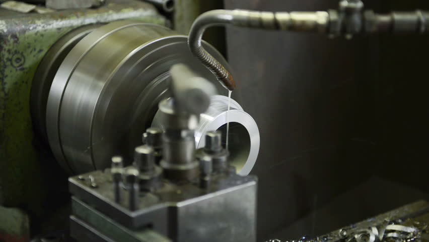 An industrial service repairmen labouring in workshop, selective focus, working on industry machine 
