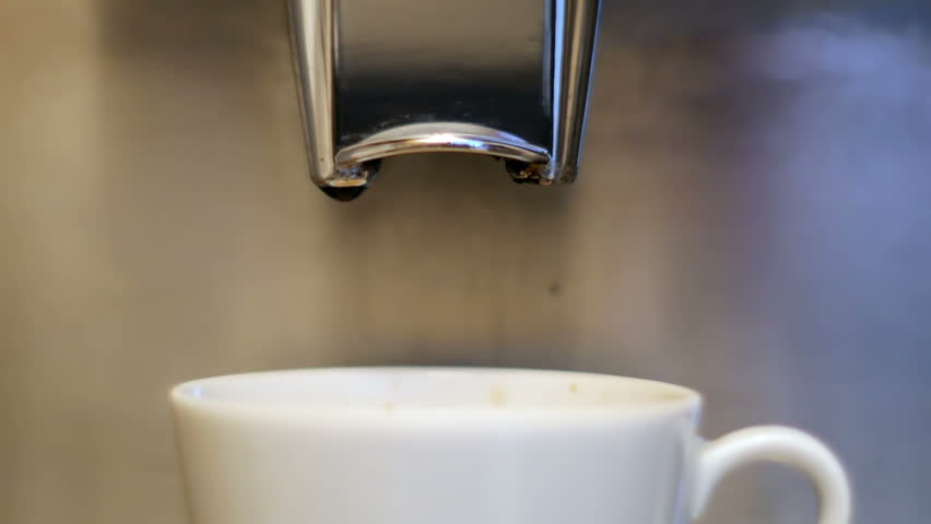 Coffee cup filled to the brim. Coffee maker fills cup of coffee to the brim.