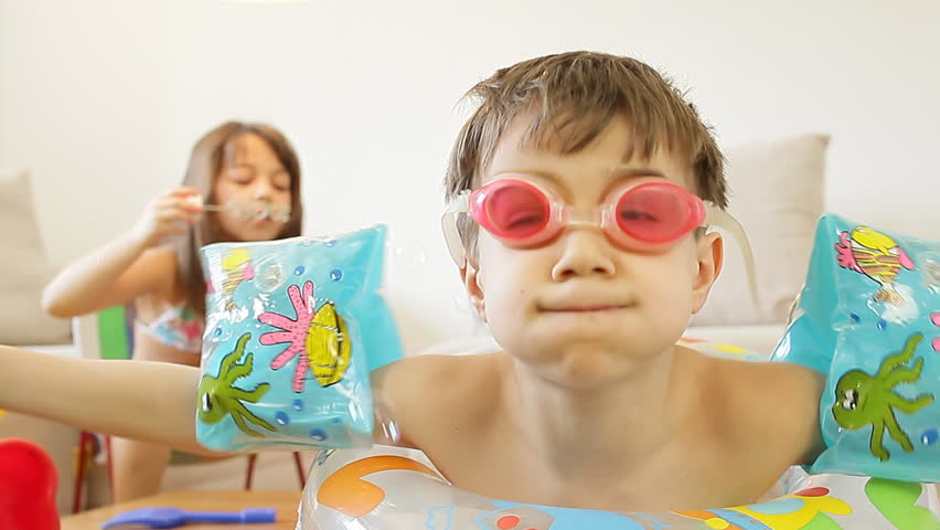 Kids playing in the living room, fantasize about they are on a beach. 
