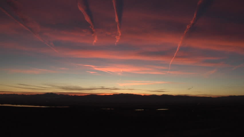 Red Contrails in the Sunset. Both natural and contrail-generated cirrus are decorated by the setting sun