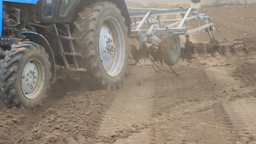 Tractor starts ploughing the field