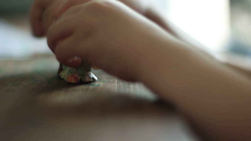 Child moulding from clay. 1080p.
