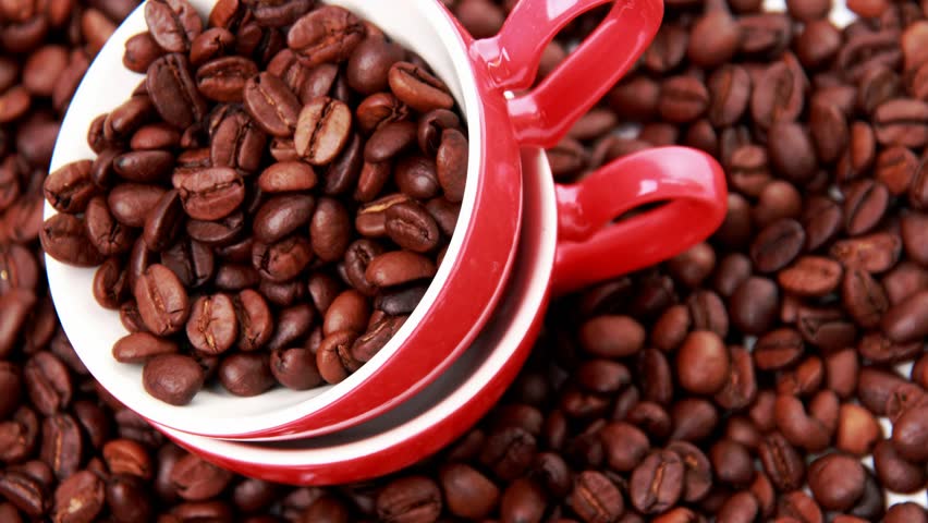  white and red ceramic cups heart symbol full of coffee beans on valentine day
