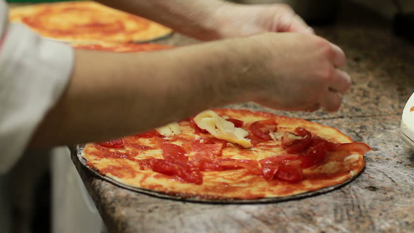 Chef Hand Making Italian Pizza.

