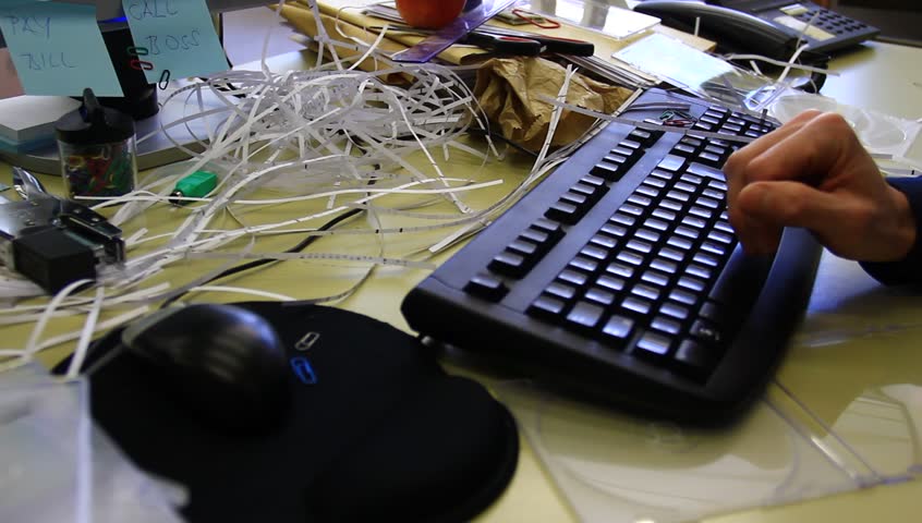 Lazy worker typing. Messy office. Total chaos.