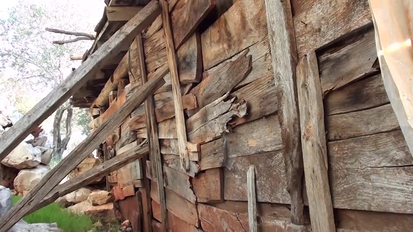 Wooden buttress, wall of a ruining hut