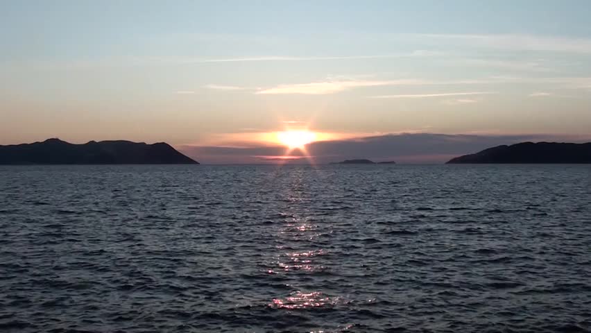 Sunset, sea, ripples waves, clouds, islands, mute