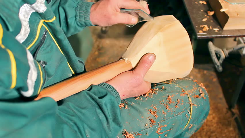 artisan prepares traditional musical instrument and processes the wood with glass,video clip ; Creation of folk musical instrument