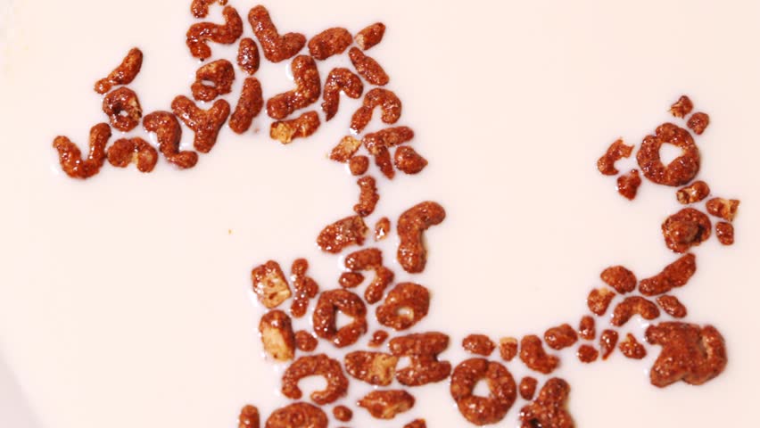 Spoon of cereals put in milk, zoom in